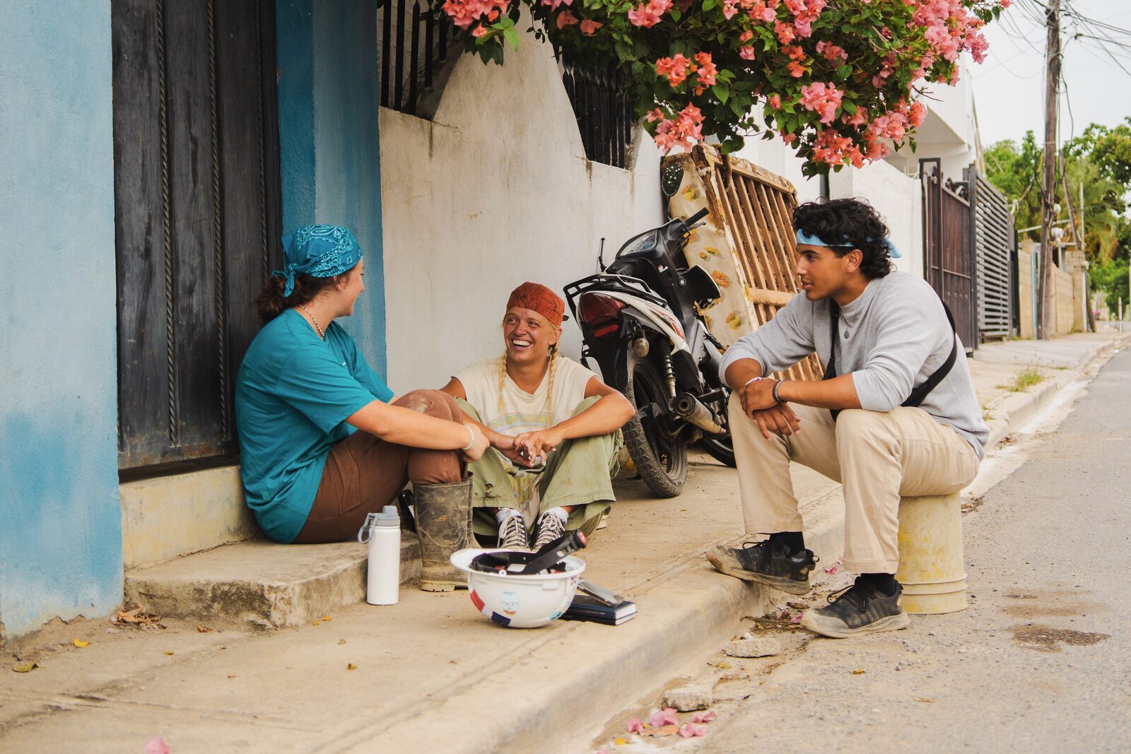 A Trip Leader talking with Builders on a street during an HXP trip